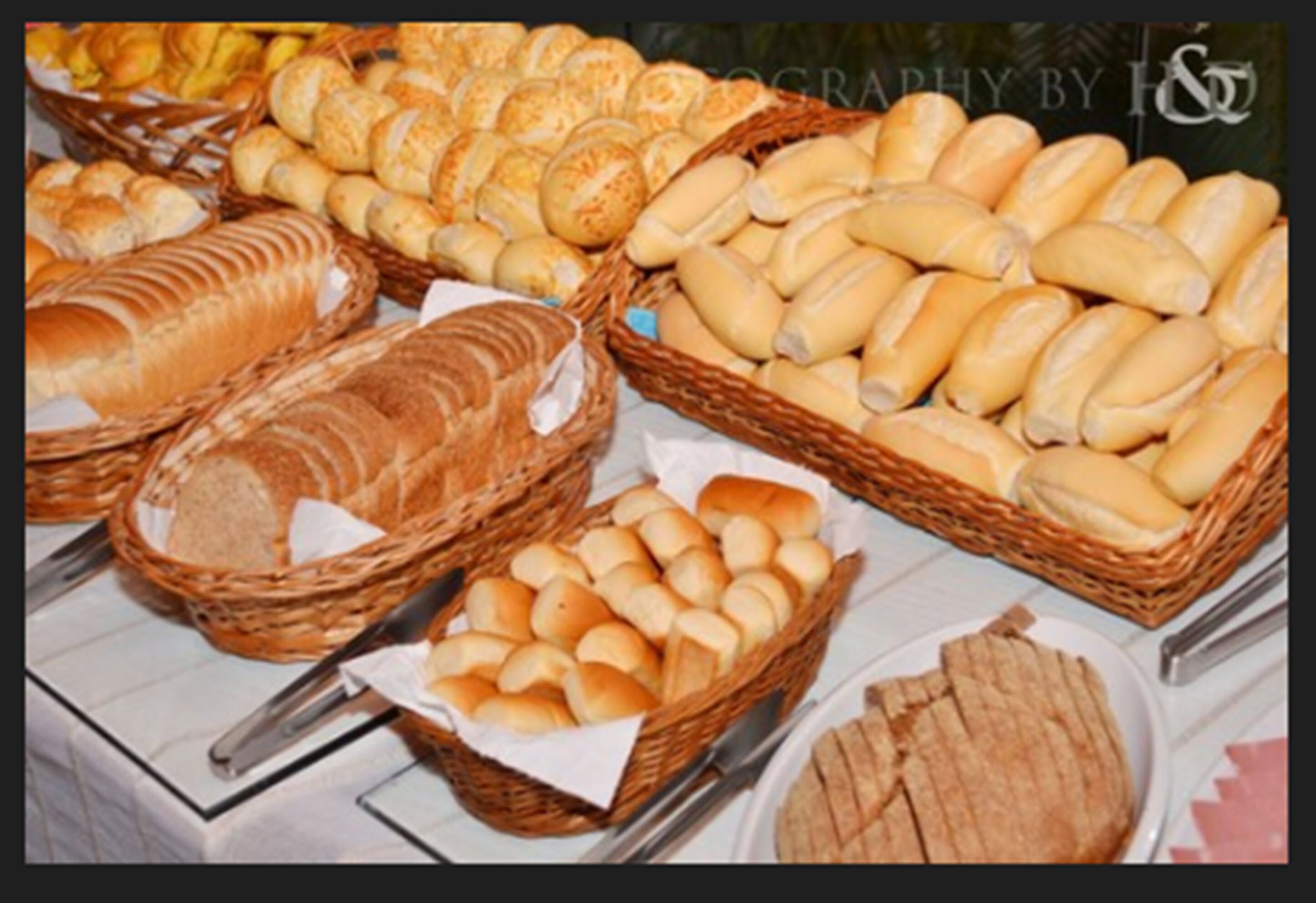 A variety of breads displayed in baskets on a table.