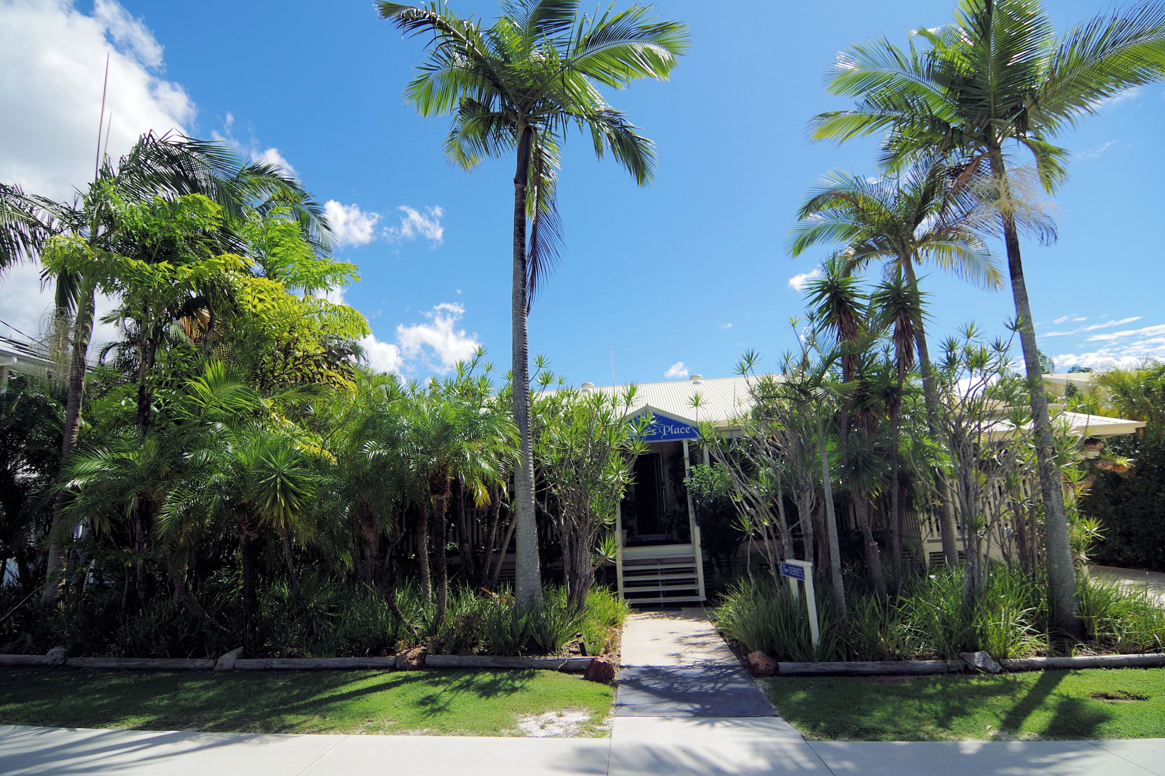 A pathway leading to a building with a sign indicating a place for relaxation.