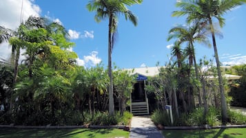 A pathway leading to a building with a sign indicating a place for relaxation.