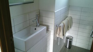 Ducha, artículos de higiene personal gratuitos y toallas