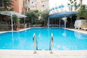 Seasonal outdoor pool, pool umbrellas, pool loungers