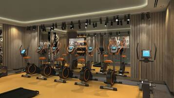 A gym with multiple cardio machines, mirrors, and a large mirror reflecting the room.