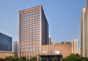 A tall, modern building with a grid of windows and a sign that reads "INTERCONTINENTAL." - Intercontinental Tangshan by IHG (Tangshan)