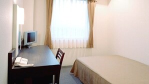 A hotel room with a single bed, a desk with a telephone, a television, and a window with curtains. - Hirata MAPLE Hotel (Izumo)