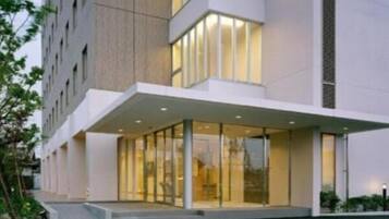 Contemporary building with a clean design, featuring large windows and a welcoming entrance.