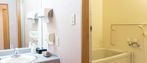 A bathroom with a sink, mirror, and a walk-in shower.