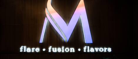 A sign with a large illuminated 'M' and the words 'flare fusion flavors' below it.