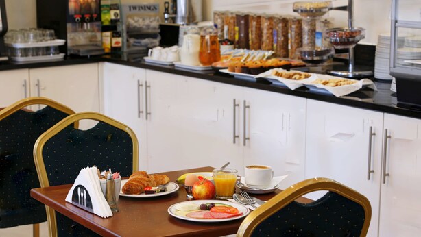 A breakfast buffet with various food items and a coffee station. - Best Western London Highbury (London)