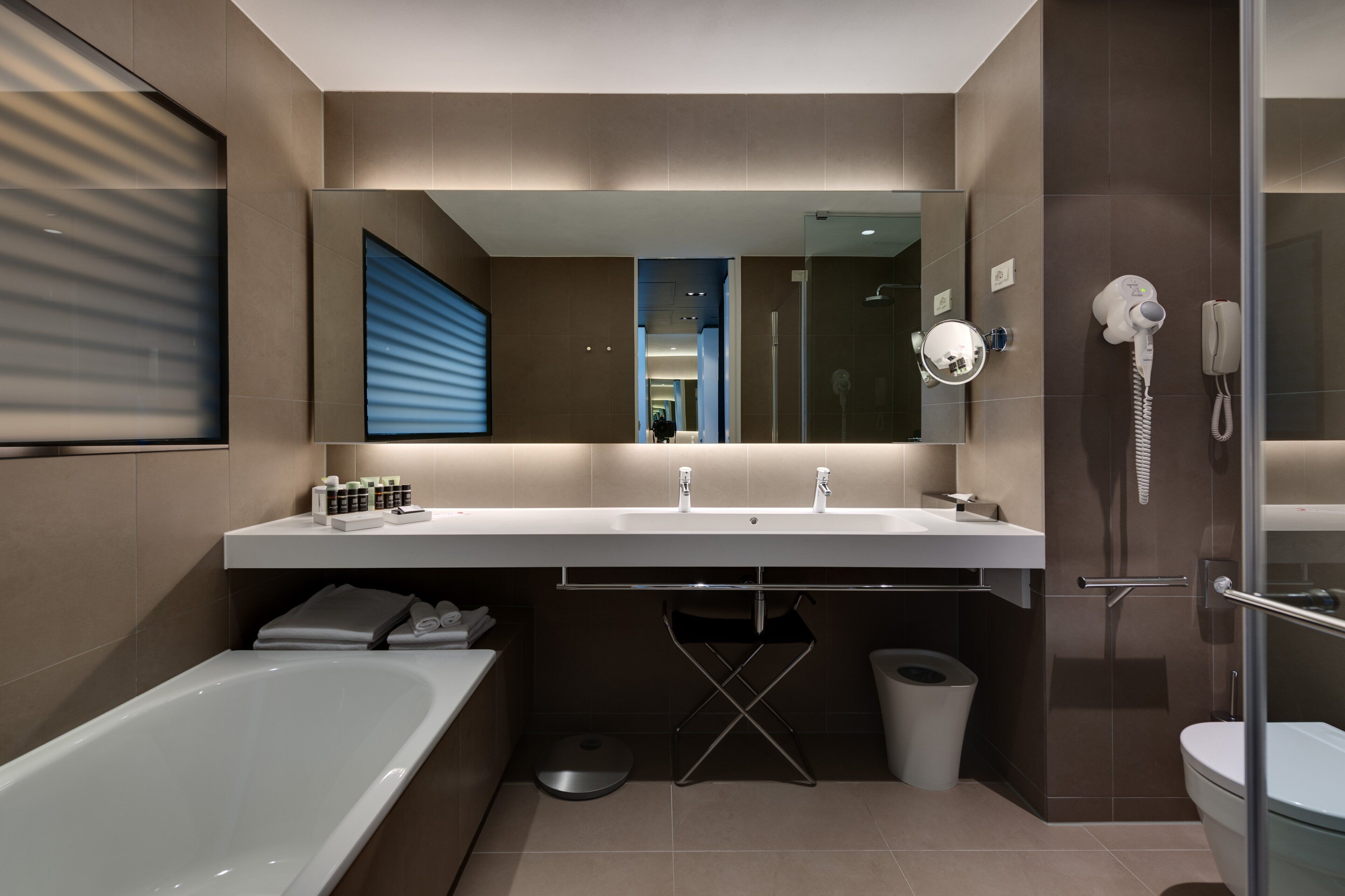 separate bathtub and shower, rainfall showerhead, designer toiletries