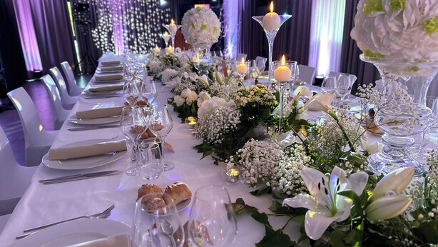 A banquet hall with long tables set for a formal event, featuring floral centerpieces and candles. - Best Western Plus Thionville Centre (Thionville)