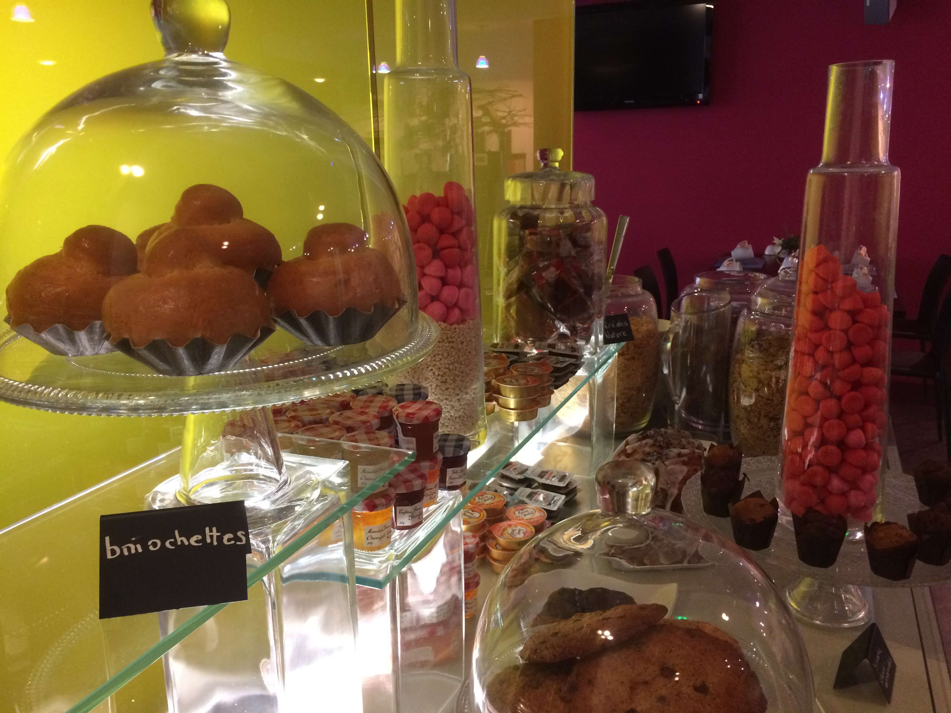 A dessert display with various sweets and pastries, including a section labeled "bni ochettes".