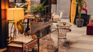 A modern interior with a bar area, seating, and a surfboard decoration. - Aethos Hotel Milan (Milan)