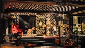 A modern interior with a stage, seating, and a variety of decorative items. - Aethos Hotel Milan (Milan)