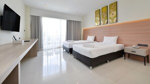 A modern hotel room with two beds, a desk, a TV, and artwork on the wall. - BS RESIDENCE Suvarnabhumi (Bangkok)