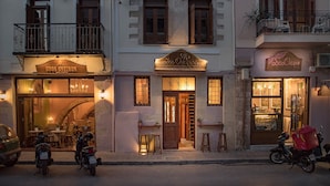 A street view of Odos Oneiron cafe and hotel with outdoor seating and a visible entrance. - Odos Oneiron Hotel (Chania)