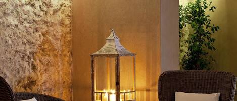 A cozy seating area with wicker furniture and a lantern.