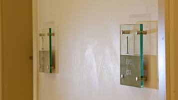 Two glass doors with metal handles and a green strip, one labeled "1" and the other "2".