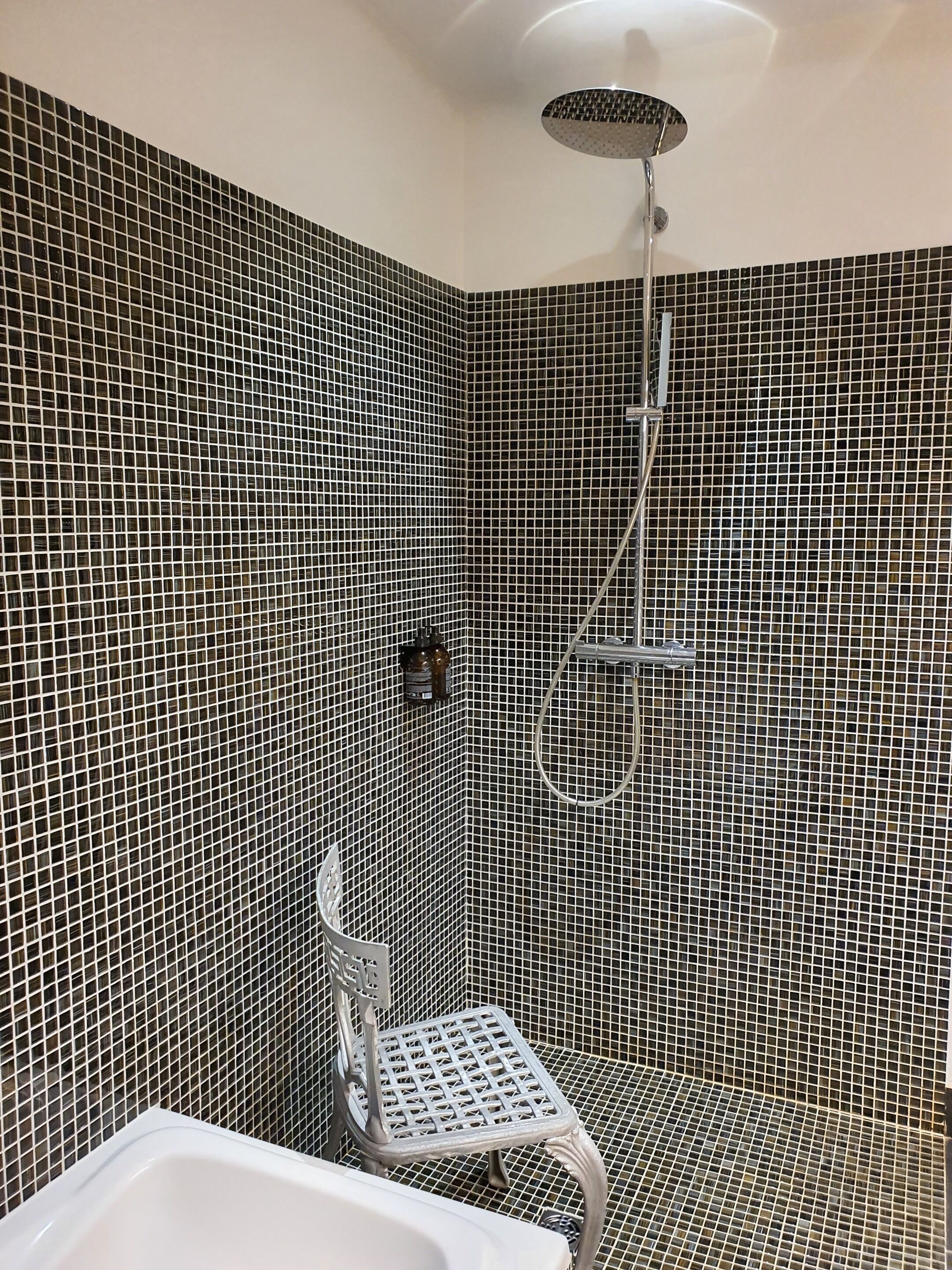 A bathroom with a shower, a toilet, and a sink.