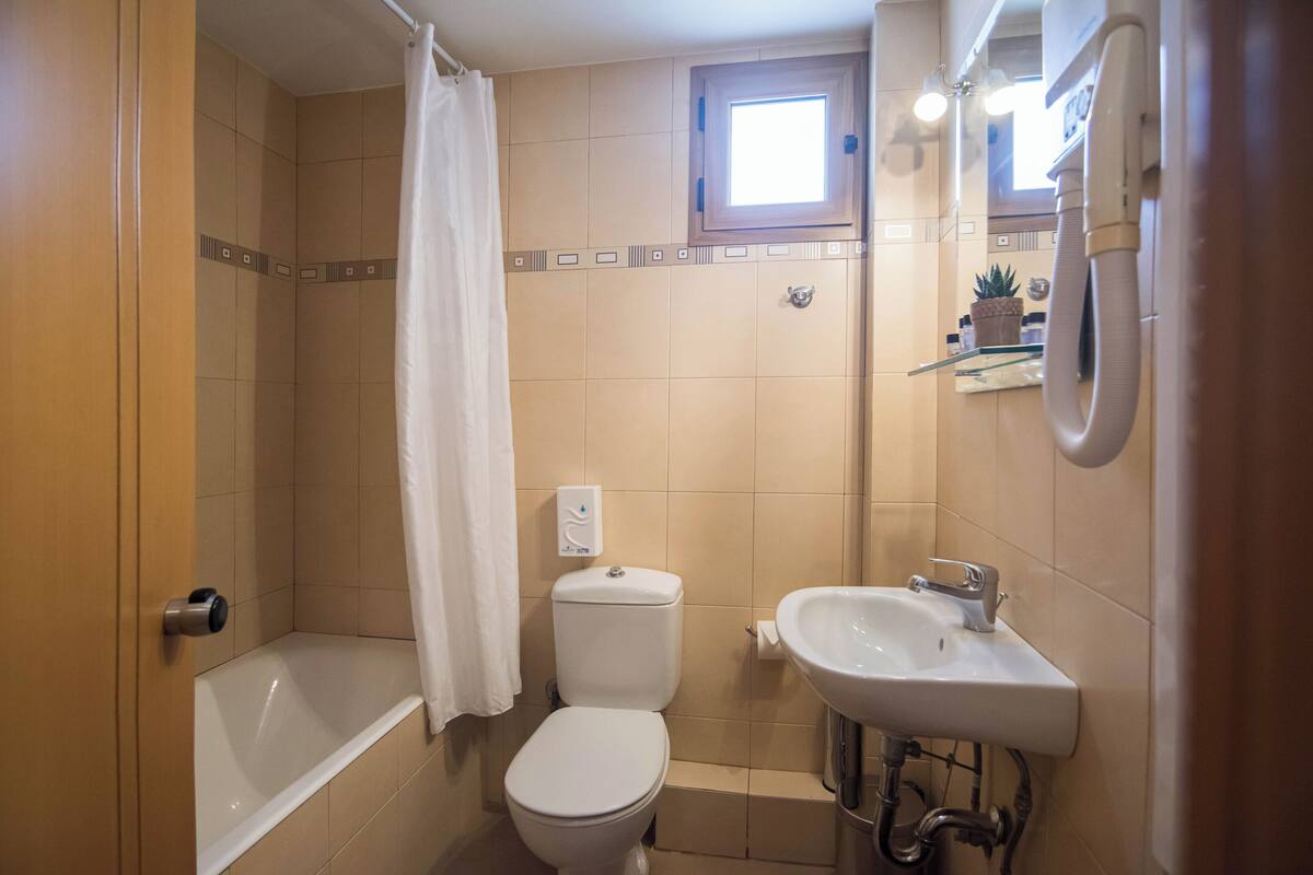 designer toiletries, hair dryer, towels, soap