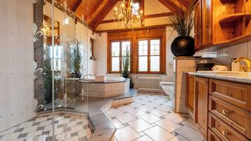 Chalet Kitzbuehel - Grand Lodge | Bathroom | Rainfall showerhead, free toiletries, hair dryer, bathrobes