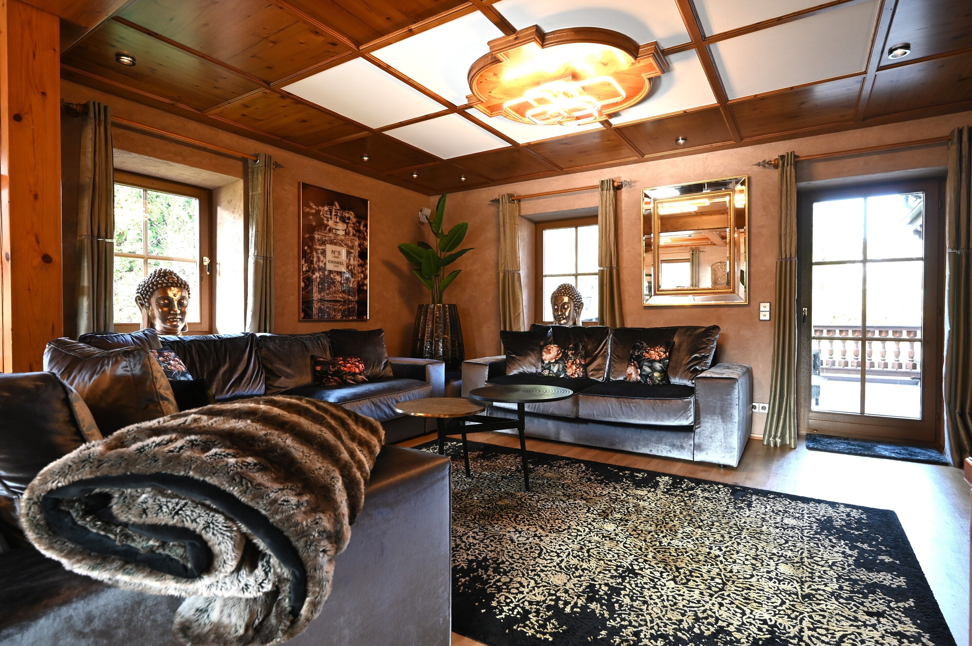 A cozy living room with a sofa, a coffee table, and a large window.