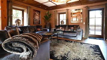 A cozy living room with a sofa, a coffee table, and a large window.