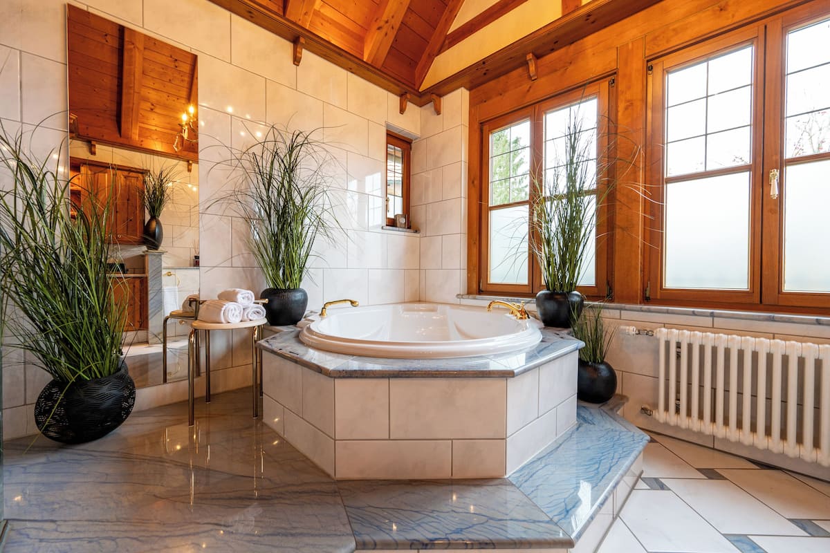 chalet kitzbuehel - grand lodge | bathroom | rainfall showerhead, free toiletries, hair dryer, bathrobes