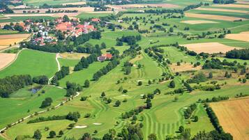 Experience golfing amidst lush greenery and scenic views.