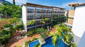 A multi-story hotel with balconies, a swimming pool, and lush greenery. - Deevana Plaza Krabi (Krabi)