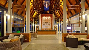 A spacious lobby with high ceilings, wooden beams, and a central reception desk. - Deevana Plaza Krabi (Krabi)