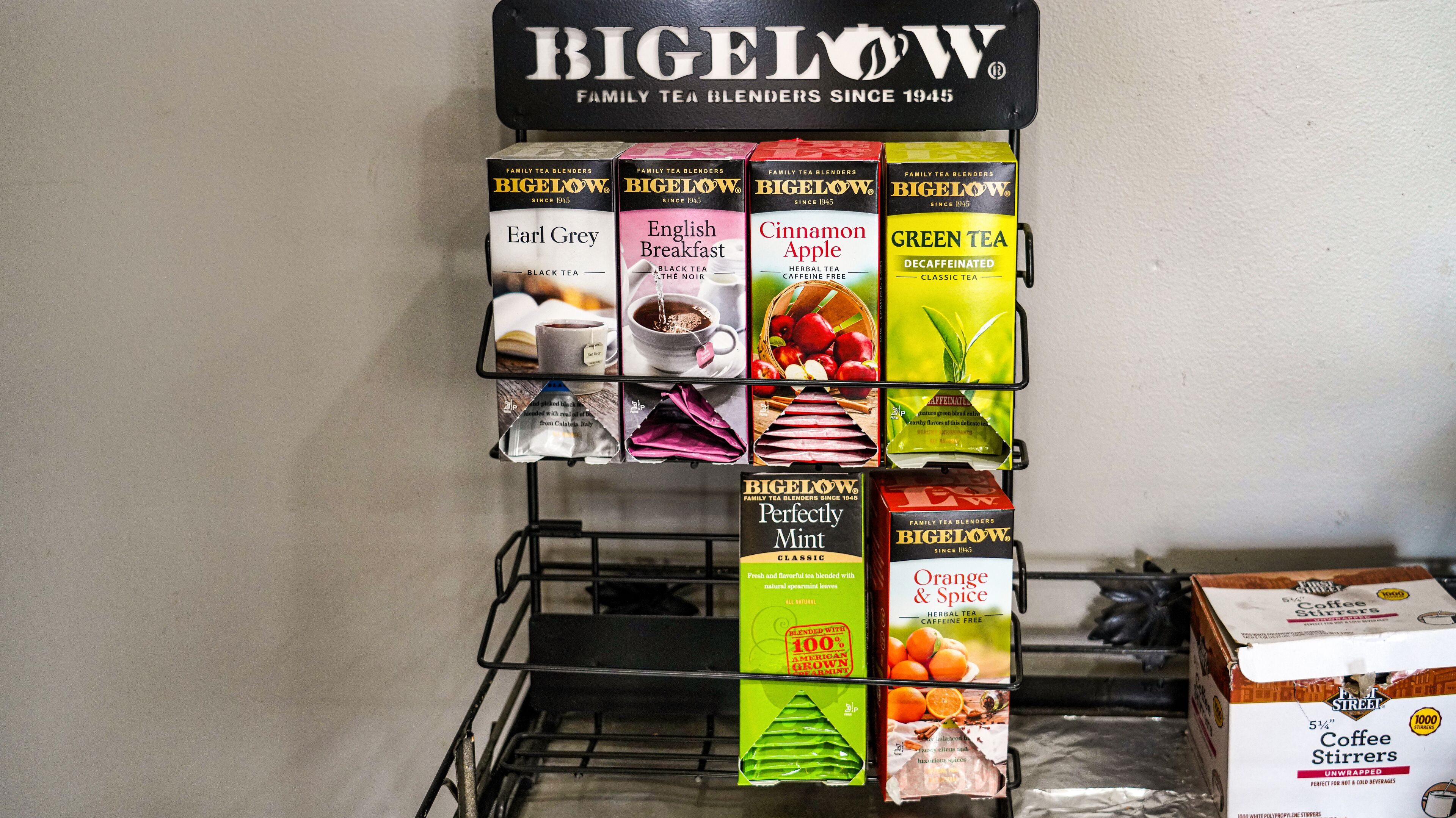 A display of Bigelow tea blends on a metal rack.