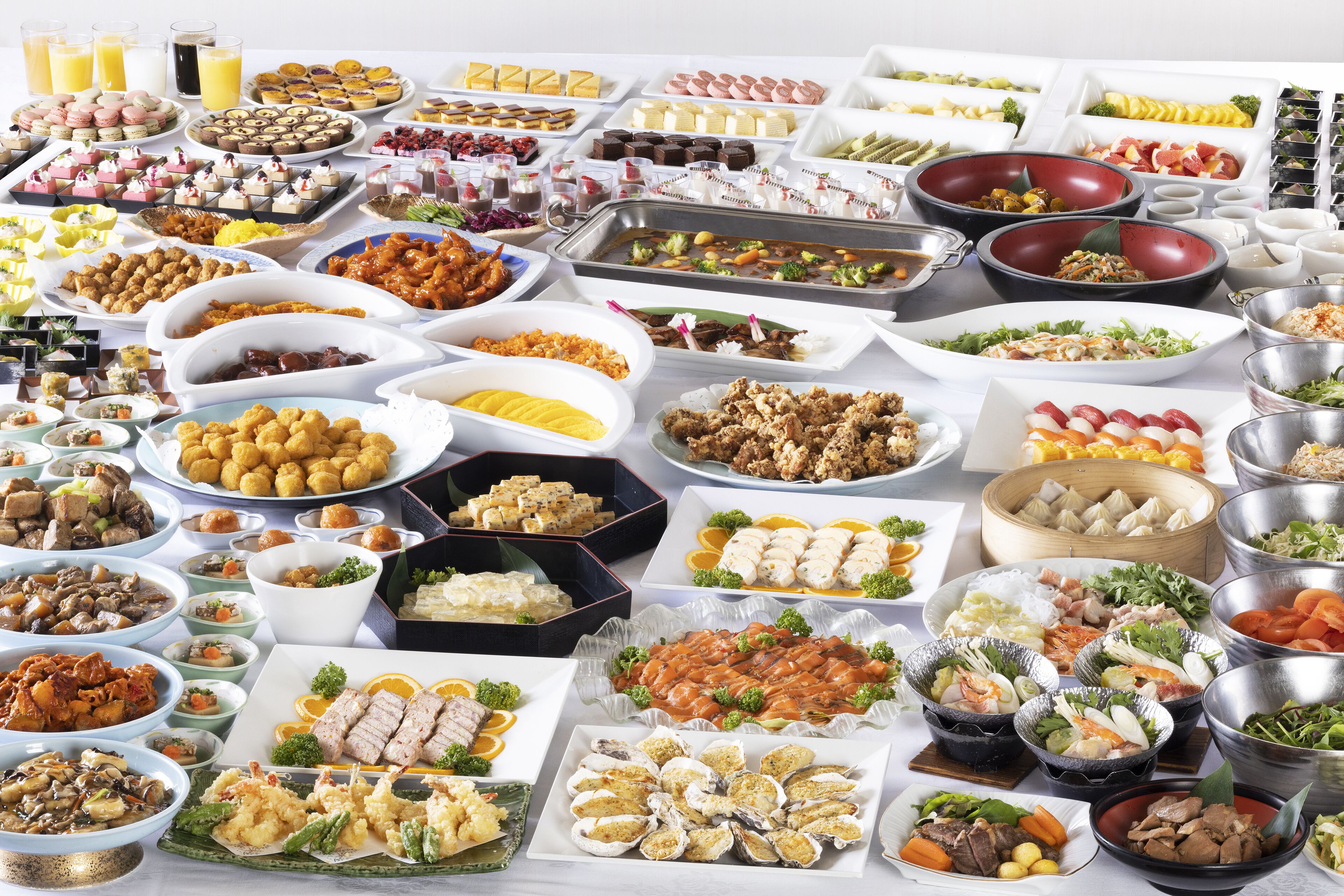 A buffet with various dishes and drinks.