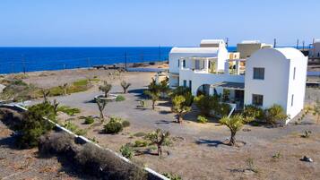 On the beach, black sand, sun-loungers, beach umbrellas