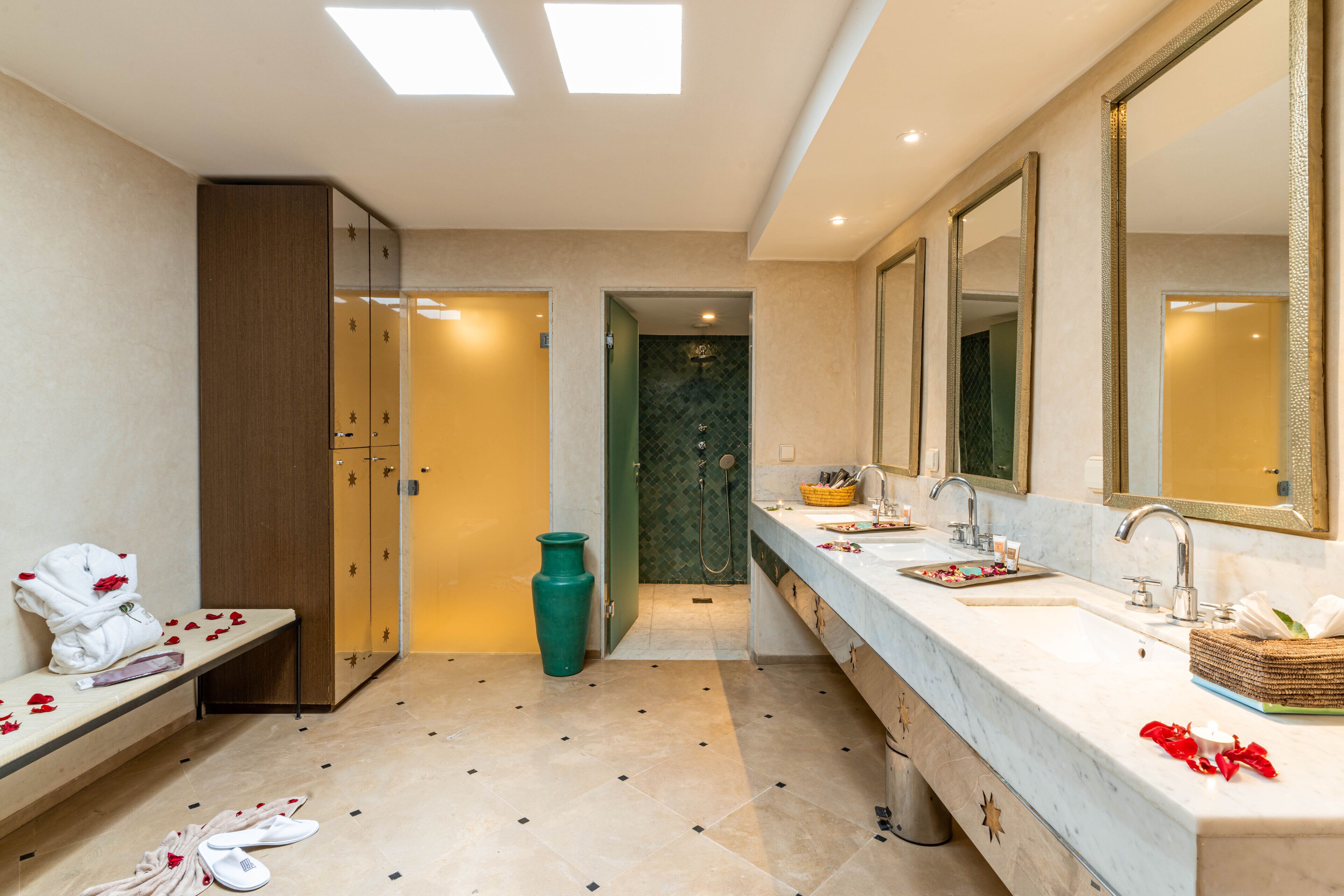 Ein modernes Badezimmer mit einem langen Waschtisch, zwei Waschbecken und einem großen Spiegel.