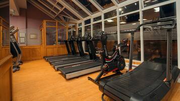 A gym with treadmills, a stationary bike, and exercise equipment.