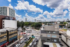 A cityscape with a prominent building featuring a large sign for 'García'. - Golden Star (Curitiba)