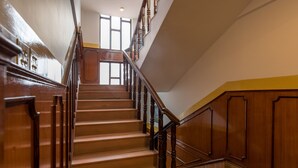 A grand staircase with wooden railings and a polished floor, leading to an upper level. - Hotel Thamel (Kathmandu)