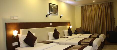 Deluxe Triple Room | Pillowtop beds, individually decorated, desk, blackout drapes