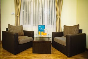 Deluxe Triple Room | Living area | 24-inch TV with digital channels