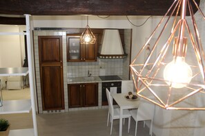 Appartement Deluxe, coin cuisine | Coin séjour