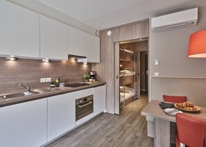 Family apartment - 5p | Sleeping corners with a triple bunk bed and a double bed | Private kitchen | Fridge, microwave, coffee/tea maker, electric kettle