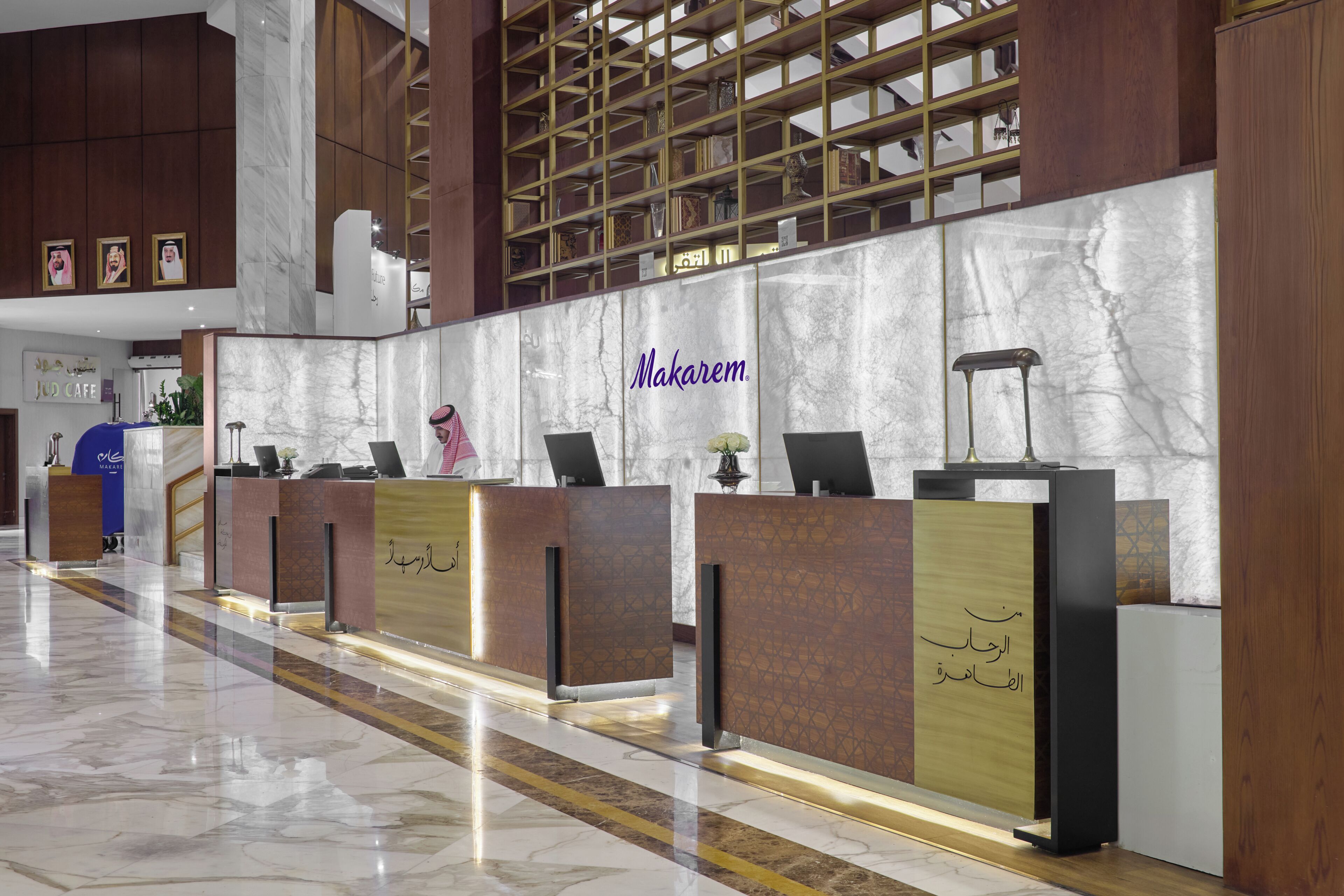 A reception area with marble walls and a Makarem sign.