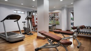 A gym with exercise equipment including a treadmill, elliptical, and weight bench. - Premier Hotel Falstaff (Sandton)