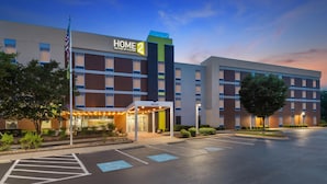 A hotel with a modern design, featuring a prominent 'HOME 2' sign, a covered entrance, and a parking lot. - Home2 Suites by Hilton Lexington Park Patuxent River NAS, MD (Lexington Park)