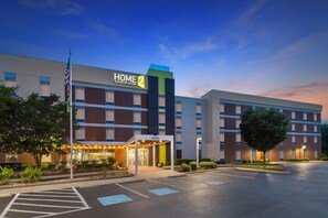 A hotel with a modern design, featuring a prominent 'HOME 2' sign, a covered entrance, and a parking lot. - Home2 Suites by Hilton Lexington Park Patuxent River NAS, MD (Lexington Park)
