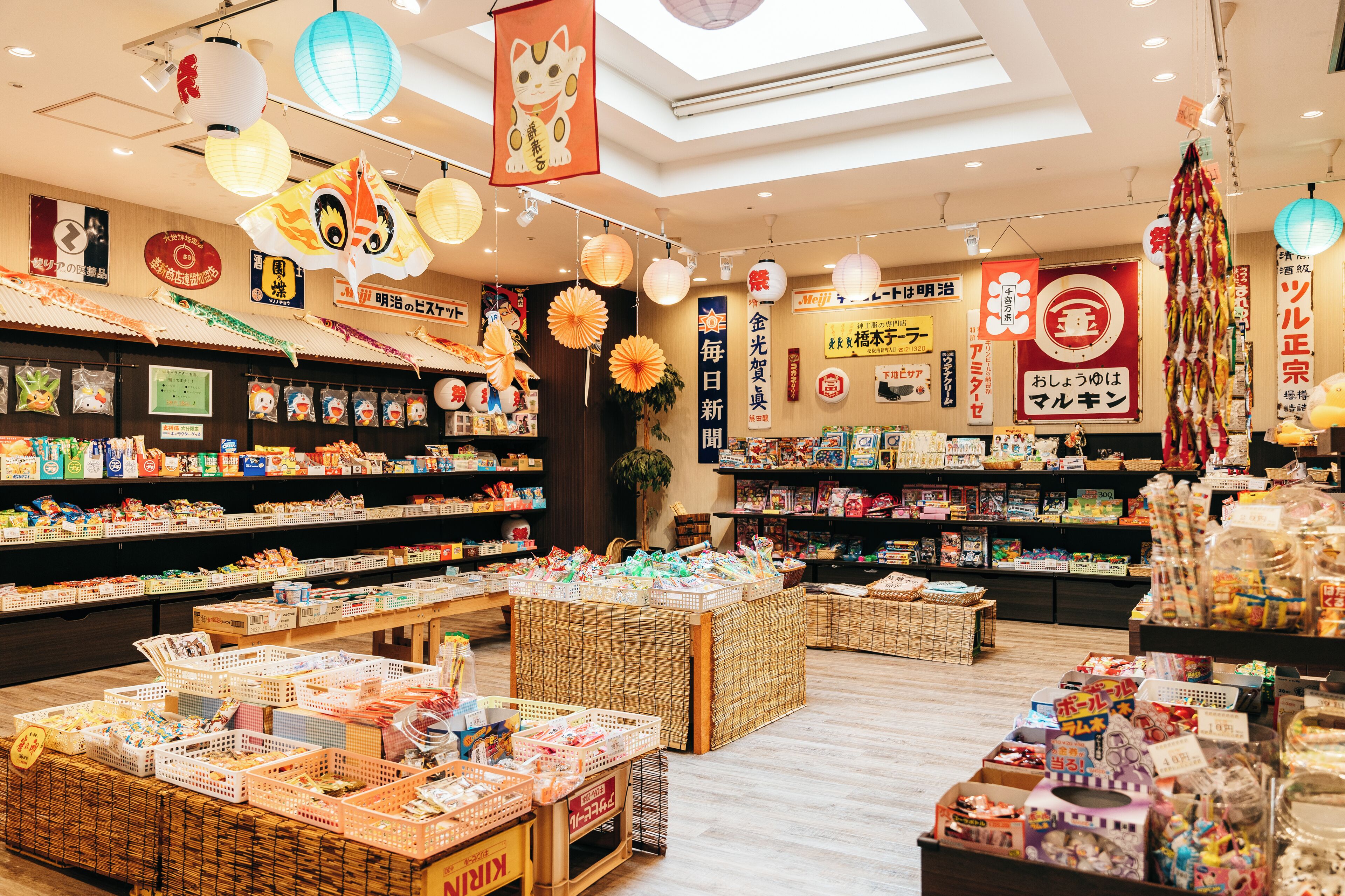 A brightly lit store with various products on shelves and tables, including snacks and toys.
