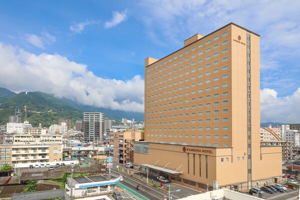 A large hotel building with multiple floors and a prominent sign.