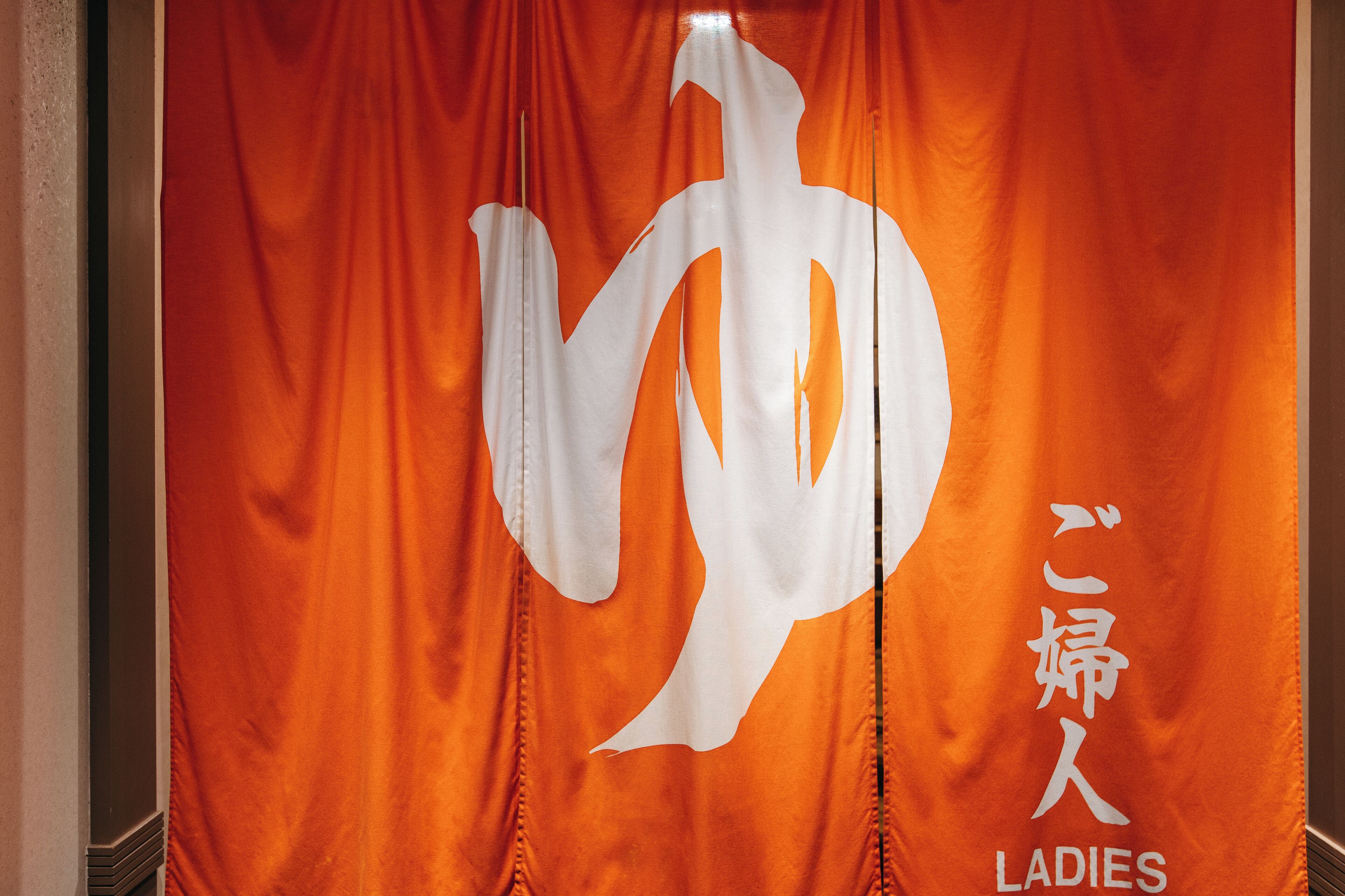 A banner with a large white symbol and Japanese text.