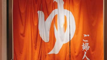 A banner with a large white symbol and Japanese text.