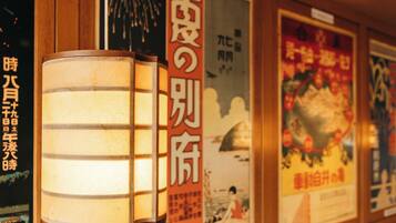 A wall with posters and a traditional Japanese lantern.